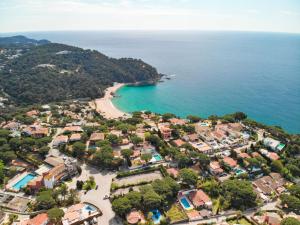 an aerial view of a small town with a beach at El Trull Apartments in Lloret de Mar