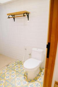 a bathroom with a toilet on a tile floor at Casa Amarta - Canggu in Canggu