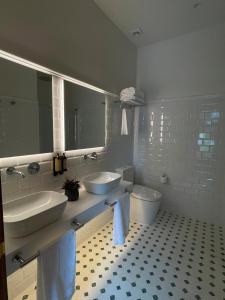 a bathroom with two sinks and a toilet at Hotel El Rosal de Cudillero in Cudillero