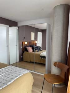 a bedroom with a bed and a large mirror at Chez Charly in Bordeaux