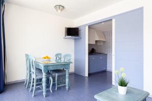 a kitchen with a table and chairs in a room at El Trull Apartments in Lloret de Mar +4 photos