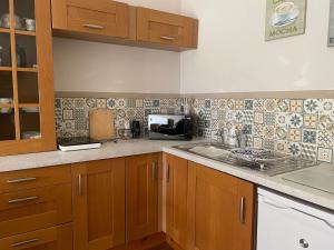 a kitchen with a sink and a microwave at Formby Point in Liverpool