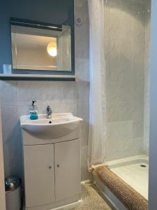 a bathroom with a sink and a bath tub at Formby Point in Liverpool