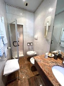 a bathroom with a toilet and a sink and a shower at Hotel Clelia in Deiva Marina +63 photos