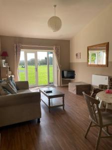 a living room with a couch and a table at Another Place in Formby