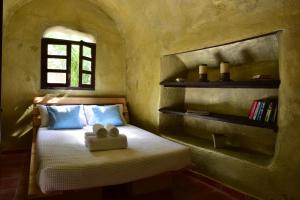 a bedroom with a bed with a teddy bear on it at Ducato Wine Village in Megalochori