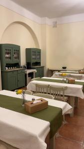 a kitchen with several tables and chairs in a room at Casa de Oaspeți Vulcan in Braşov