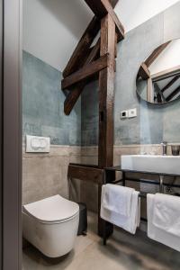 La salle de bains est pourvue de toilettes blanches et d'un lavabo. dans l'établissement LANTerna Boutique Hotel, à Srbac