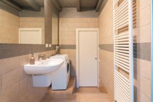 a bathroom with a sink and a toilet at Appartamento Scaligero Mameli Borgo Trento in Verona +7 photos