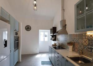 a kitchen with blue cabinets and a sink at MyStay - Cantinho do Açor in Vale de Açor