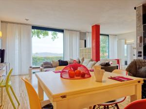 a living room with a table with a bowl of fruit on it at Arzignano Charm: Modern Home With Parking! in Arzignano