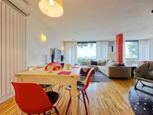 a living room with a table and red chairs at Arzignano Charm: Modern Home With Parking! in Arzignano