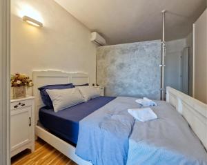 a bedroom with a blue bed in a room at Arzignano Charm: Modern Home With Parking! in Arzignano