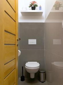 a bathroom with a toilet and a sink at Castle Corner Apartment in Budapest +14 photos