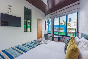 a bedroom with a large bed with a large window at Hotel Guatatur in Guatapé +80 photos
