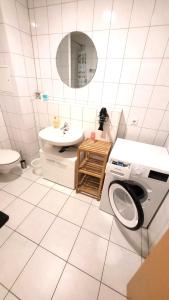 a bathroom with a washing machine and a sink at Apartment am Bahnhof und Uniklinik in Mainz