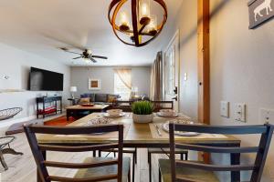 a dining room and living room with a table and chairs at Meadow Creek Cottage in Wimberley