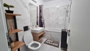 y baño con aseo, lavabo y ducha. en Apartament Ariana Rasnov, en Râșnov