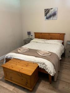 a bedroom with a large bed with a wooden headboard at Let It Be in Liverpool