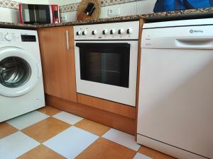 a kitchen with a dishwasher and a washer and dryer at Adosado en Alcossebre El Faro in Alcossebre