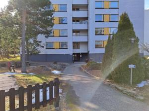 a building with a fence next to a street at Seaside apartment in Rauma