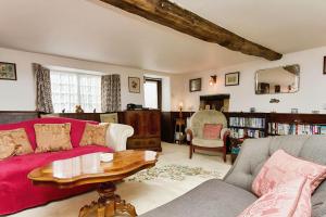 a living room with a couch and a table at Ye Olde Cottage in Niton