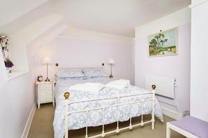 a white bedroom with a white bed in a room at Ye Olde Cottage in Niton