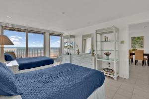 a bedroom with two beds and a view of the ocean at First level with a secluded patio in South Padre Island
