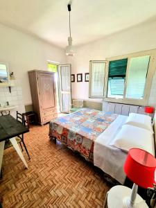 a bedroom with a large bed in a room with windows at Casa Cambini in Marina di Massa
