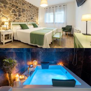 a hotel room with a bed and a bathtub at Apartamentos rurales Posada de Monfragüe con jacuzzi in Malpartida de Plasencia