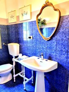 a bathroom with a sink and a toilet and a mirror at Casa Cambini in Marina di Massa