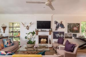 a living room with a couch and a fireplace at Fords on Fairway in Sheffield Beach