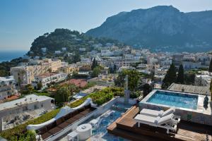 a view of a city with a swimming pool at Capri Tiberio Palace in Capri