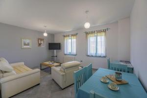 a living room with a table and a living room with a couch at Villa Boljunka in Boljun - Haus für 8 Personen in Boljun