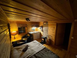 an overhead view of a room with a bed and a kitchen at Northern Light Cabin with sauna by Torneriver in Kiruna