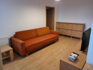a living room with a couch and a tv at Apartmán Neva Trnava in Trnava