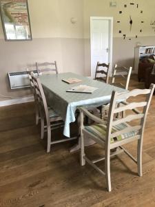 a dining room table with chairs and a blue table cloth at Strawberry Fields in Liverpool +8 photos