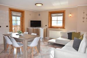a living room with a table and a couch at Appartamento Trela 3 in Livigno