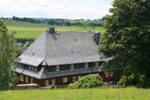 a large red house with a gray roof at Verlegerhaus Seiffen in Kurort Seiffen