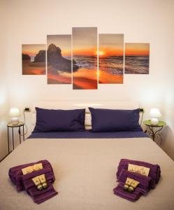 a bedroom with a bed with a sunset over the ocean at [Free Parking & Wi-Fi] 5 min to Hospital Cisanello in Pisa