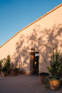 a building with a shadow on the side of it at Hotel-Masia Can Farrés in El Bruc