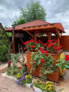 a wooden gazebo with a bunch of flowers at Airport16 bed and breakfast in Budapest