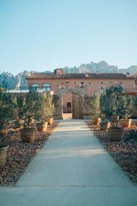 a walkway in front of a building with plants at Hotel-Masia Can Farrés in El Bruc +37 photos