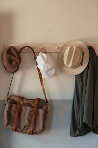 a hat and a purse hanging on a wall at Ranch Motel & Leisure Club in San Antonio