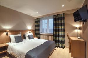 Voodi või voodid majutusasutuse Hotel Pavillon Du Zoute toas