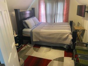 a small bedroom with a bed and a window at Mo Short Term Rentals in Mount Vernon