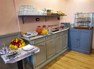 a kitchen with a table with fruit on it at Hotel Camilla Firenze in Florence