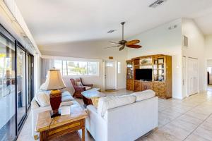 a living room with a couch and a table at Canal-side Charisma in Key Colony Beach