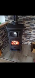 a stove in a room with a brick fireplace at Vikendica Rosi 