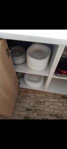 a cabinet filled with plates and bowls and dishes at Vikendica Rosi 